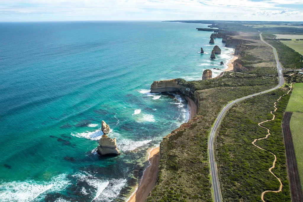 Aerial of the Great Ocean Road’s 12 Apostles and nearby coastal road.