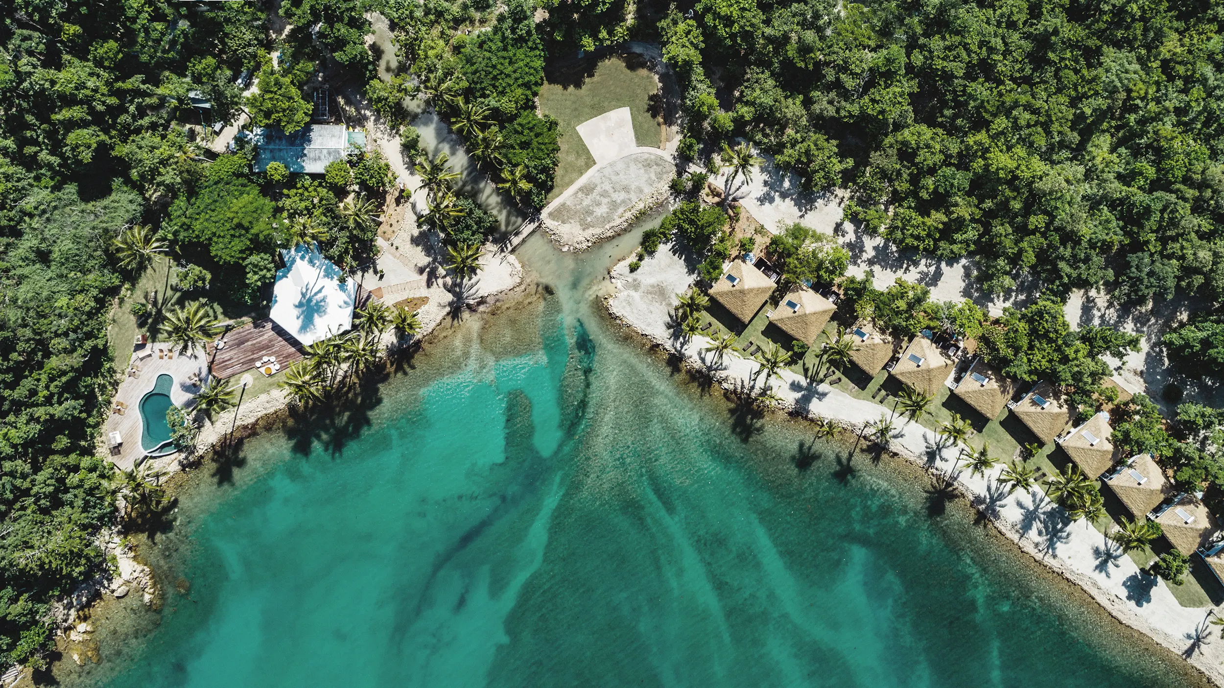 Aerial of Elysian Retreat beachfront villas and main lodge. 