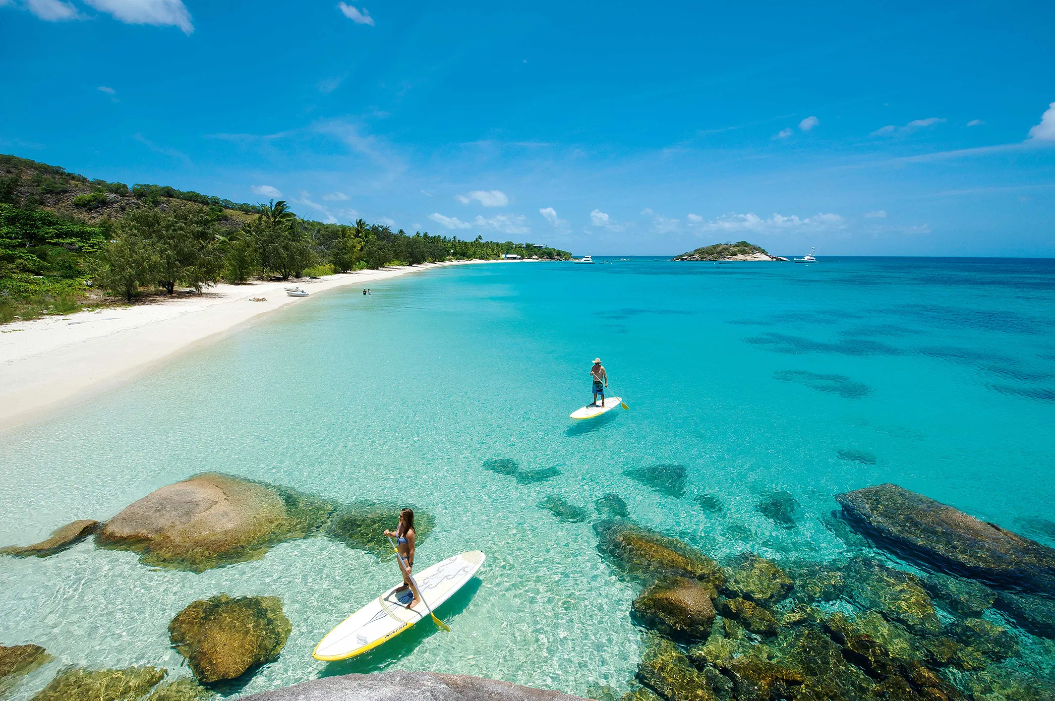 Two people on stand-up-paddleboards at Lizard Island.