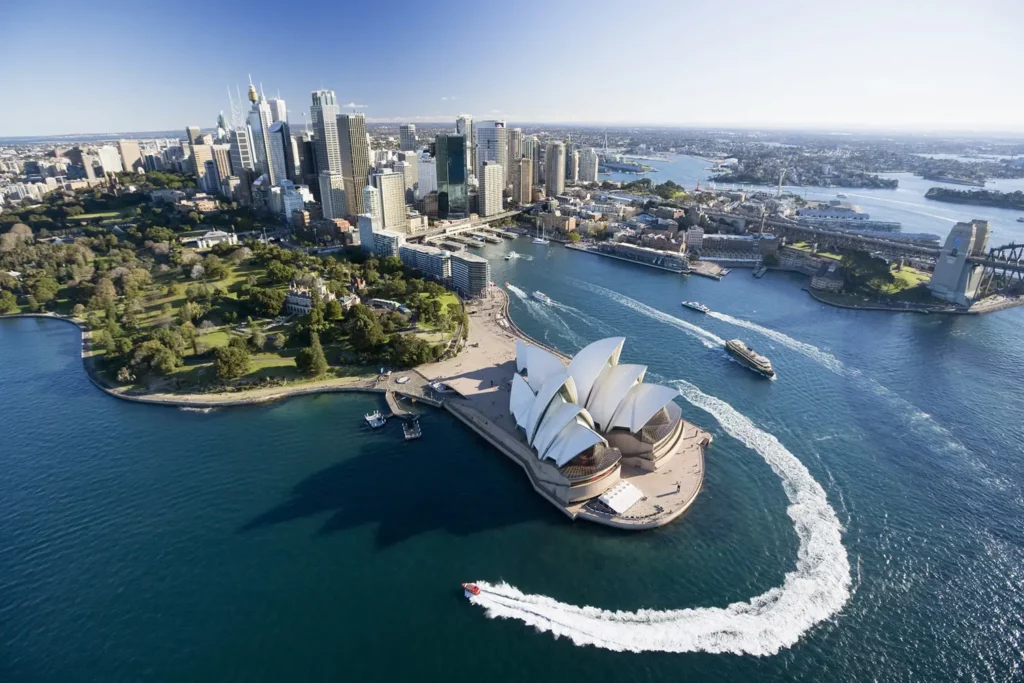 Aerial of Sydney Harbour’s main attractions, including the Sydney Opera House, Harbour Bridge, and city skyline. 