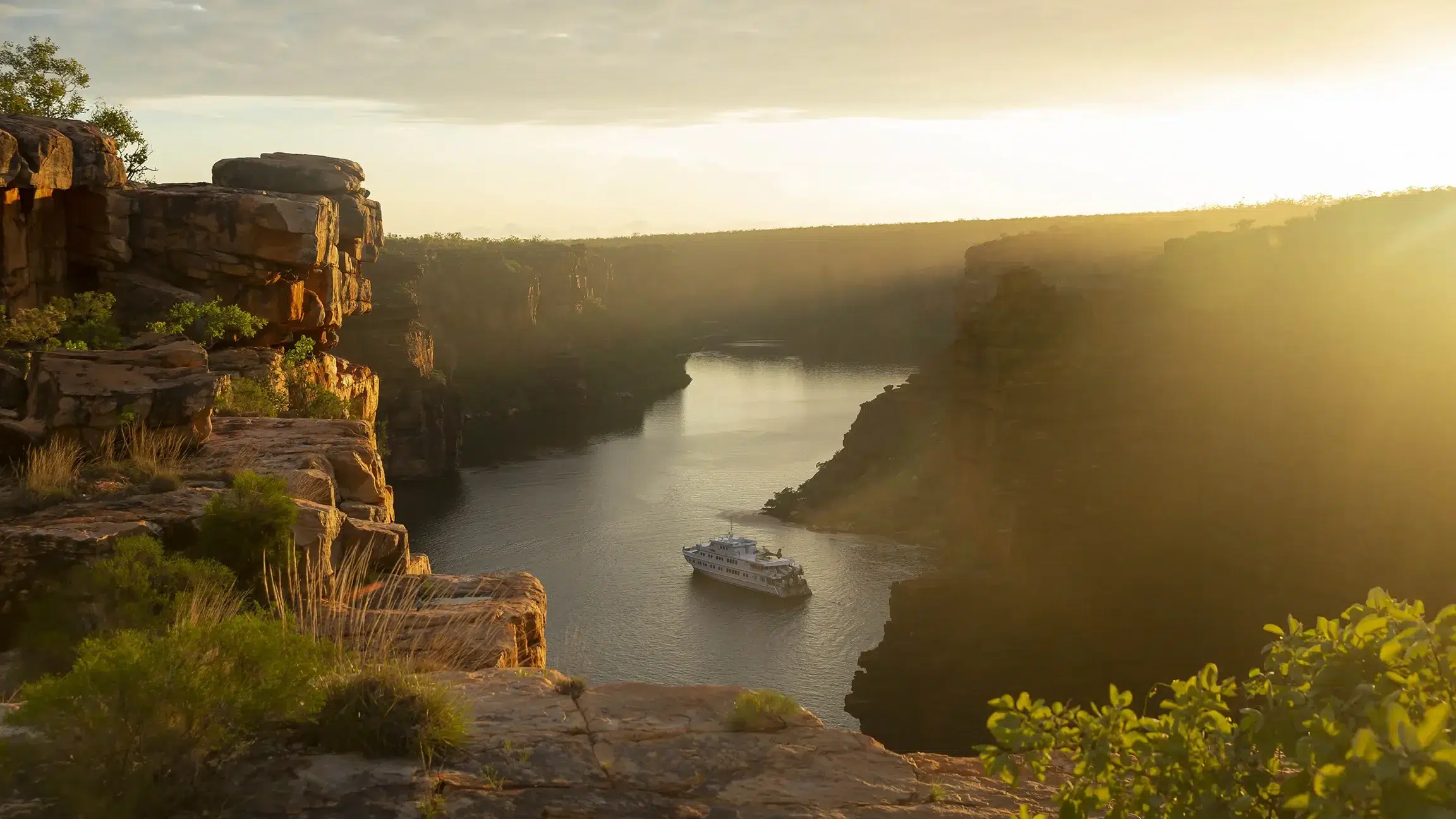 True North vessel within two steep gorges in the Kimberley, Western Australia, at golden hour