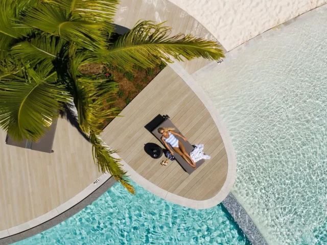 Aerial of guest relaxing near the Crystalbrook Riley pool.